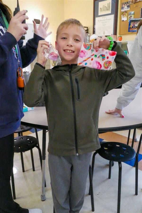 boy holding up small toys